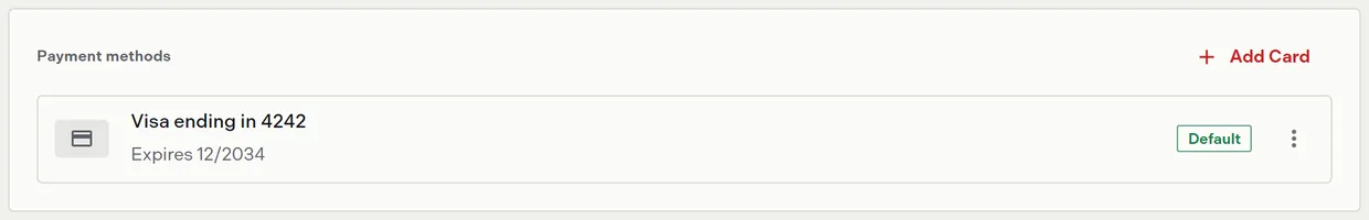 The payment methods section listing a saved card with the default chip